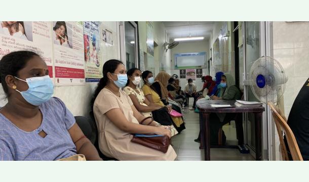 Cover Providing a bag of goods to pregnant mothers